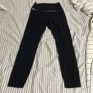 Lululemon leggings in black with a purple and pink band at the top